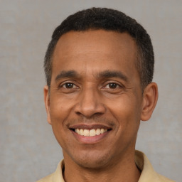 Joyful latino adult male with short  brown hair and brown eyes