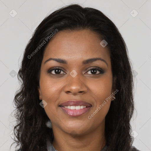 Joyful black young-adult female with long  brown hair and brown eyes