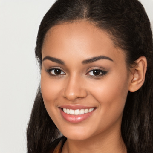 Joyful latino young-adult female with long  brown hair and brown eyes