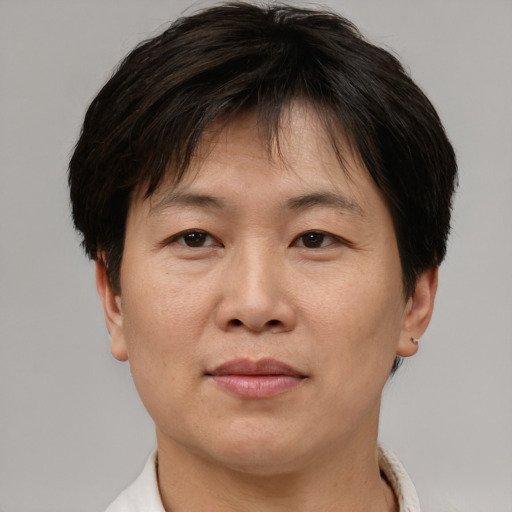 Joyful asian adult male with short  brown hair and brown eyes