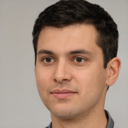 Joyful white young-adult male with short  black hair and brown eyes