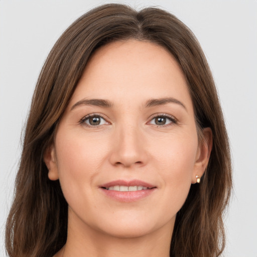 Joyful white young-adult female with long  brown hair and brown eyes