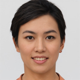 Joyful asian young-adult female with short  brown hair and brown eyes