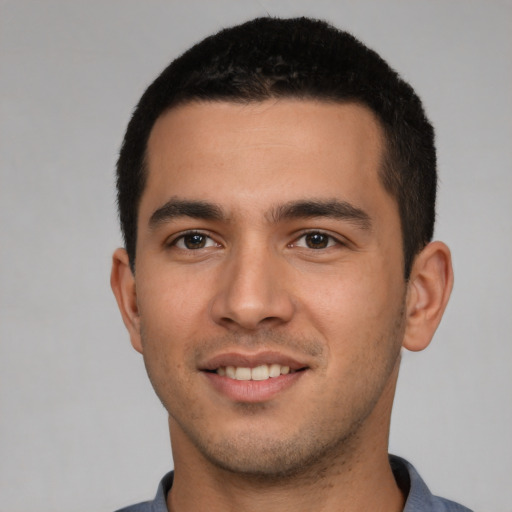 Joyful white young-adult male with short  black hair and brown eyes