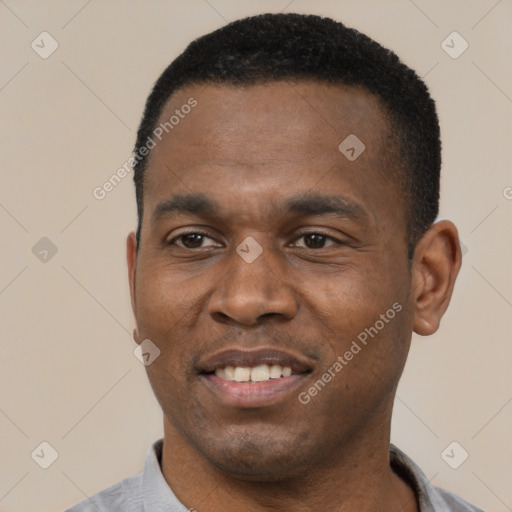 Joyful black young-adult male with short  black hair and brown eyes