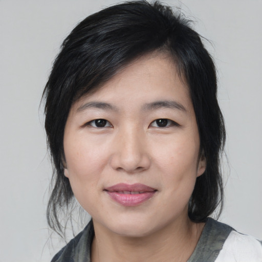 Joyful white young-adult female with medium  black hair and brown eyes