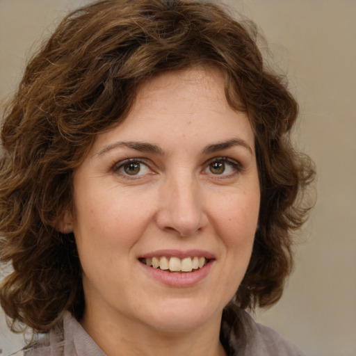 Joyful white young-adult female with medium  brown hair and green eyes