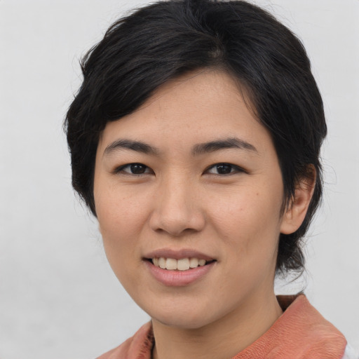 Joyful asian young-adult female with medium  brown hair and brown eyes