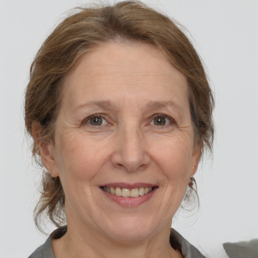 Joyful white middle-aged female with medium  brown hair and brown eyes