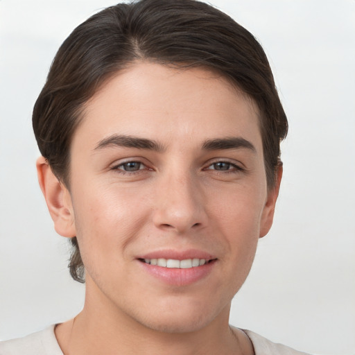 Joyful white young-adult female with short  brown hair and grey eyes