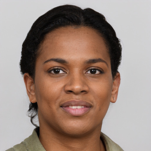 Joyful black young-adult female with short  brown hair and brown eyes