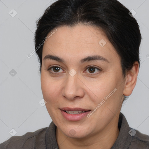 Joyful white adult female with medium  brown hair and brown eyes