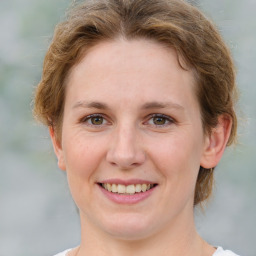 Joyful white young-adult female with medium  brown hair and green eyes