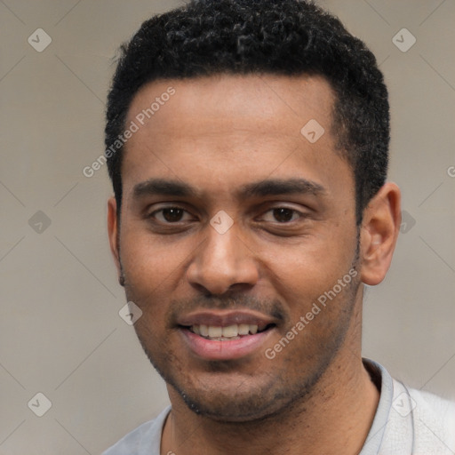 Joyful black young-adult male with short  black hair and brown eyes