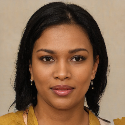 Joyful black young-adult female with medium  black hair and brown eyes