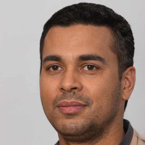 Neutral latino young-adult male with short  black hair and brown eyes