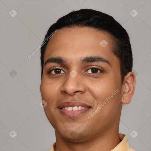 Joyful latino young-adult male with short  black hair and brown eyes