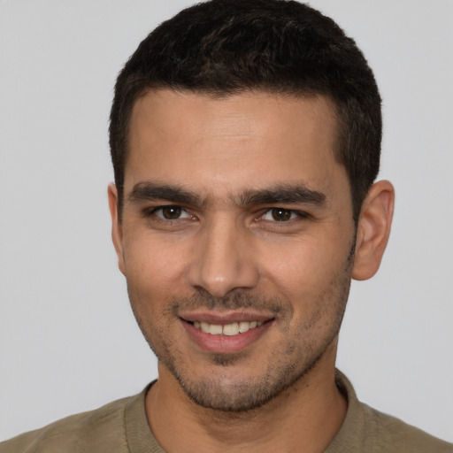 Joyful white young-adult male with short  brown hair and brown eyes