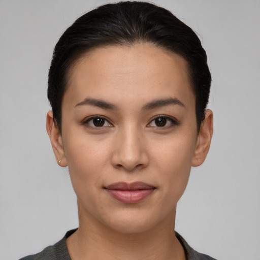 Joyful latino young-adult female with short  brown hair and brown eyes