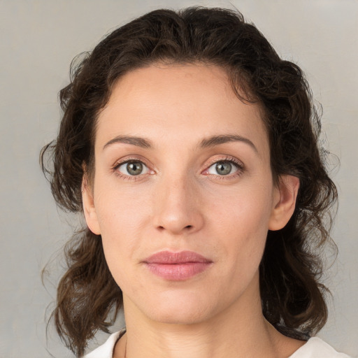 Joyful white young-adult female with medium  brown hair and green eyes