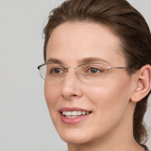 Joyful white adult female with medium  brown hair and grey eyes