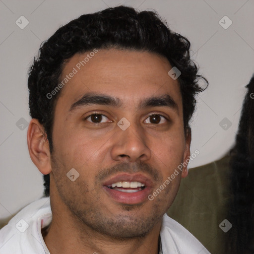 Joyful latino young-adult male with short  brown hair and brown eyes