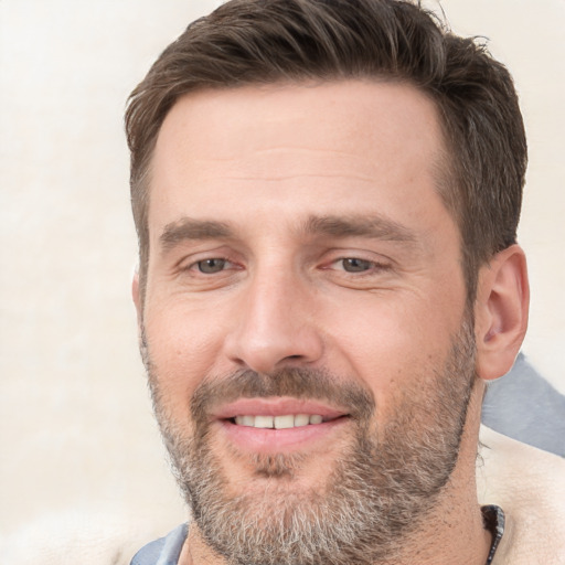 Joyful white adult male with short  brown hair and brown eyes