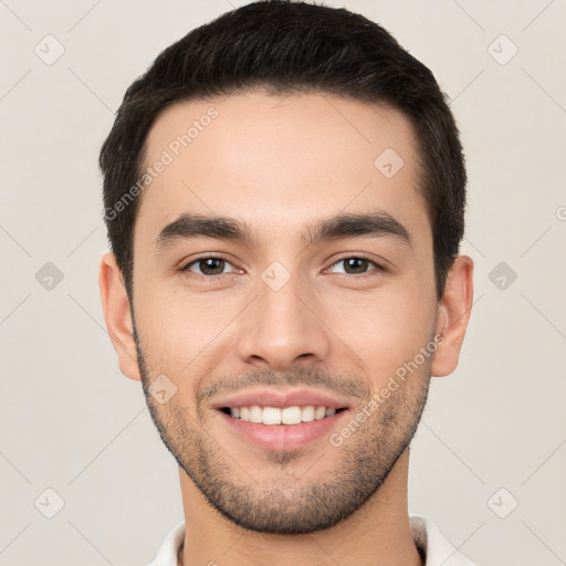 Joyful white young-adult male with short  black hair and brown eyes