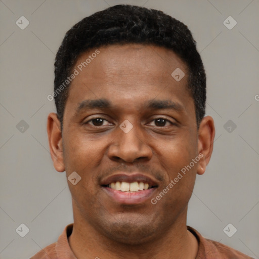 Joyful black young-adult male with short  black hair and brown eyes