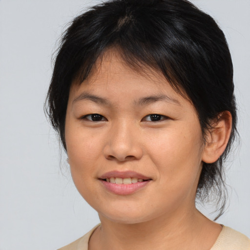 Joyful asian young-adult female with medium  brown hair and brown eyes
