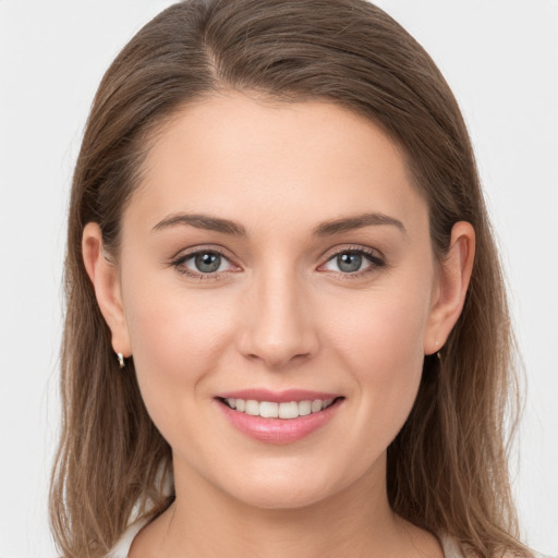 Joyful white young-adult female with long  brown hair and grey eyes