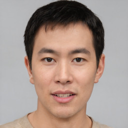 Joyful asian young-adult male with short  brown hair and brown eyes