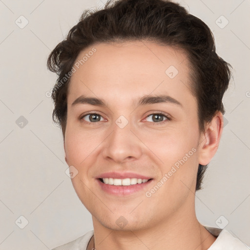 Joyful white young-adult female with short  brown hair and grey eyes