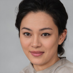 Joyful asian young-adult female with medium  brown hair and brown eyes