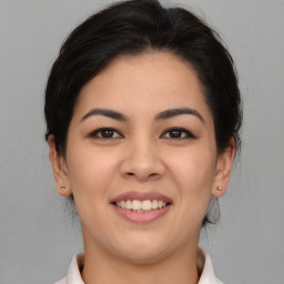 Joyful latino young-adult female with medium  brown hair and brown eyes