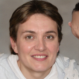 Joyful white adult female with medium  brown hair and blue eyes