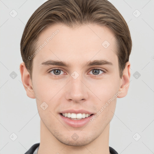 Joyful white young-adult male with short  brown hair and grey eyes