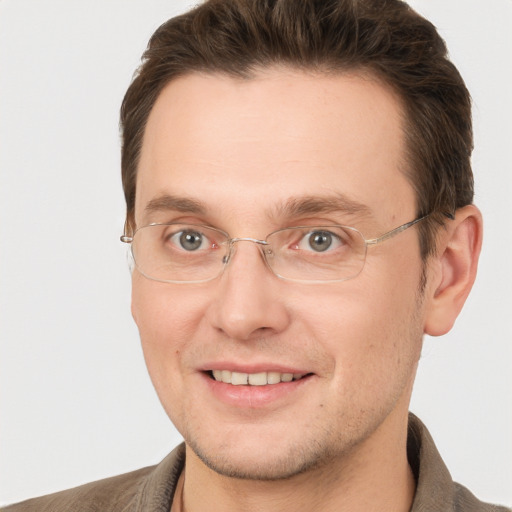 Joyful white adult male with short  brown hair and grey eyes