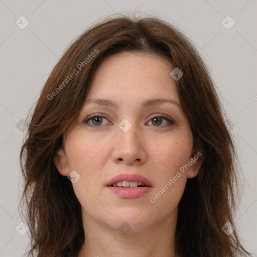 Joyful white young-adult female with long  brown hair and brown eyes