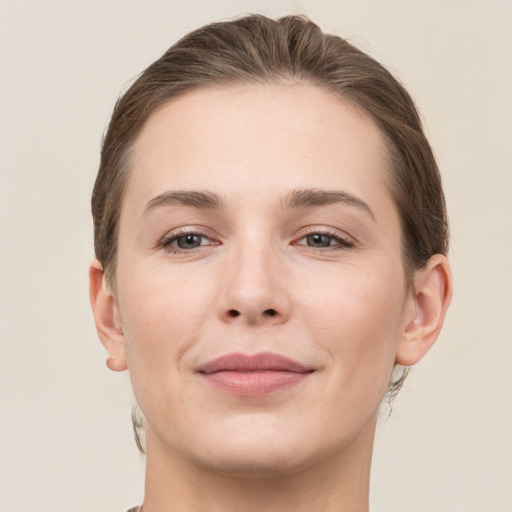 Joyful white young-adult female with short  brown hair and grey eyes