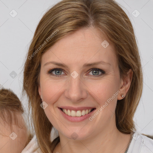 Joyful white young-adult female with medium  brown hair and blue eyes