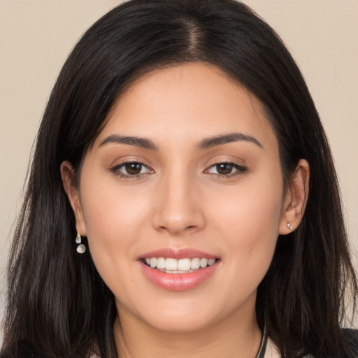 Joyful white young-adult female with long  black hair and brown eyes