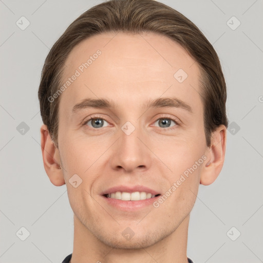 Joyful white young-adult male with short  brown hair and grey eyes