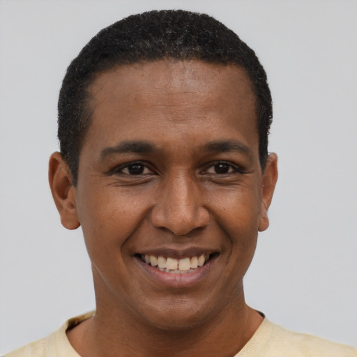 Joyful black young-adult male with short  brown hair and brown eyes