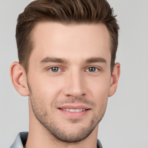 Joyful white young-adult male with short  brown hair and grey eyes