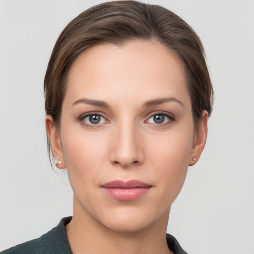 Joyful white young-adult female with medium  brown hair and grey eyes