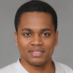 Joyful latino young-adult male with short  brown hair and brown eyes