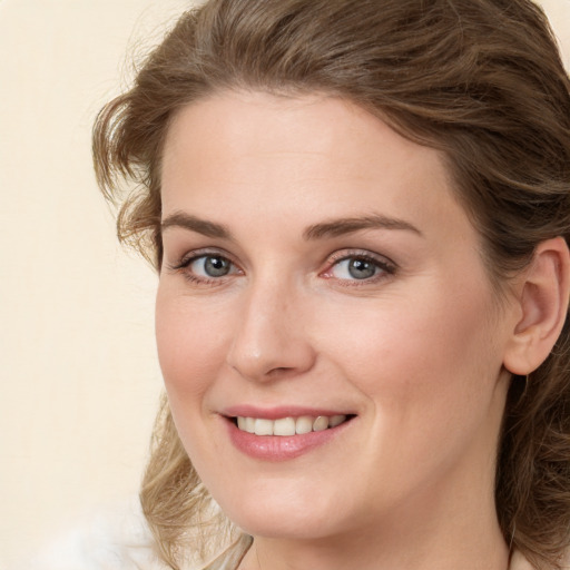 Joyful white young-adult female with medium  brown hair and green eyes