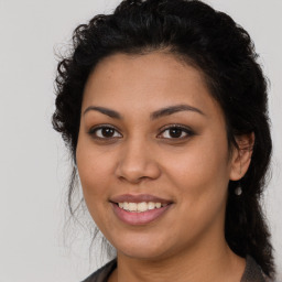 Joyful latino young-adult female with medium  brown hair and brown eyes