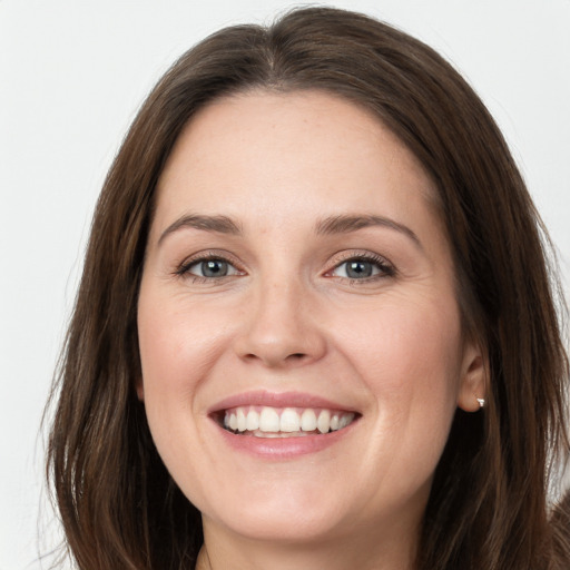 Joyful white young-adult female with long  brown hair and grey eyes